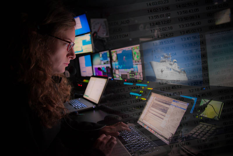 Scientist Andrea Quattrini enters data into the evenlog, one of the primary tools the science team uses to stay in contact with the shore-side science team and to record observations.