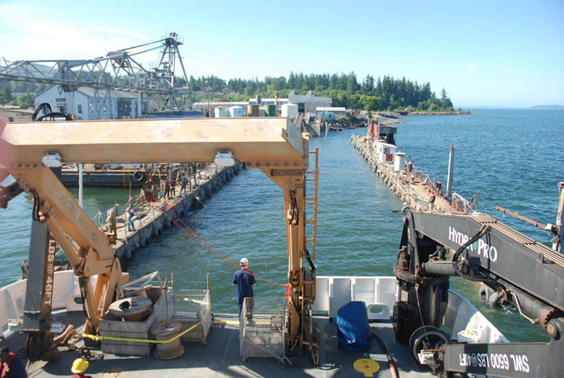 Commanding Officer Mark Wetzler observes operations as NOAA Ship Okeanos Explorer is pulled into dry dock.