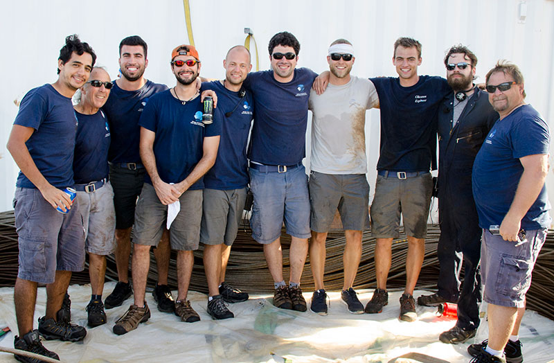 The ROV team stands proudly in the center of their coil of wire.