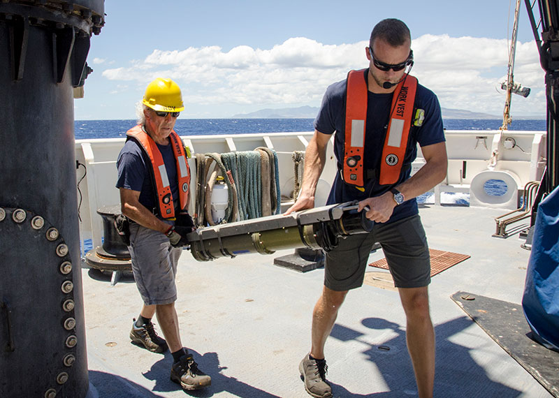 Global Foundation for Ocean Exploration Engineers Chris Ritter and Don Liberatore carry the USBL transponder after successful calibration and recovery of the unit. 