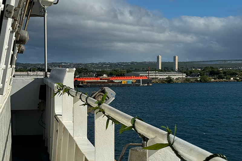 Image of the lei wrapped by our cultural liaisons, Malia and Makoa, around the railing of the bridge for the Beyond the Blue: Papahānaumokuākea Mapping 1 expedition. The bridge is the nerve center of the ship where all of the navigating and main ship operations happen.