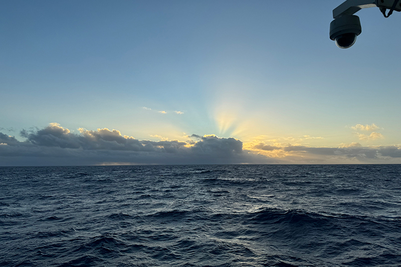 The sun is just behind this cloud bank and its light started to stream out as we finished our sunrise chant during the Beyond the Blue: Papahānaumokuākea Mapping 1 expedition.