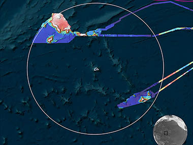  Map showing ocean topography with surveyed areas marked in varied colors and a white circle indicating a focus area. Includes NOAA logo, compass rose, and distance scale.